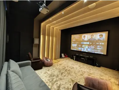 Dolby Atmos home cinema with ceiling speakers and acoustic treatment.